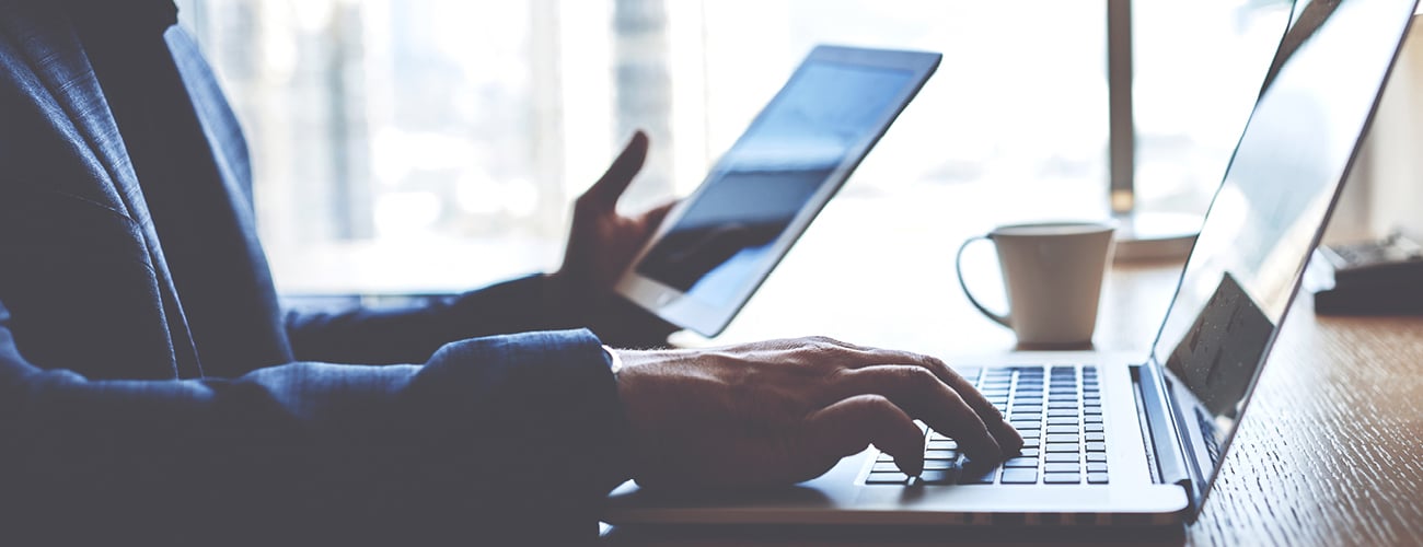 man on laptop and tablet